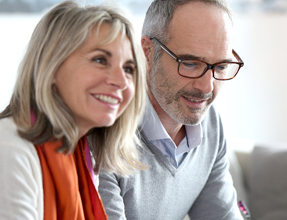 Middle aged woman and man talking to an estate lawyer.